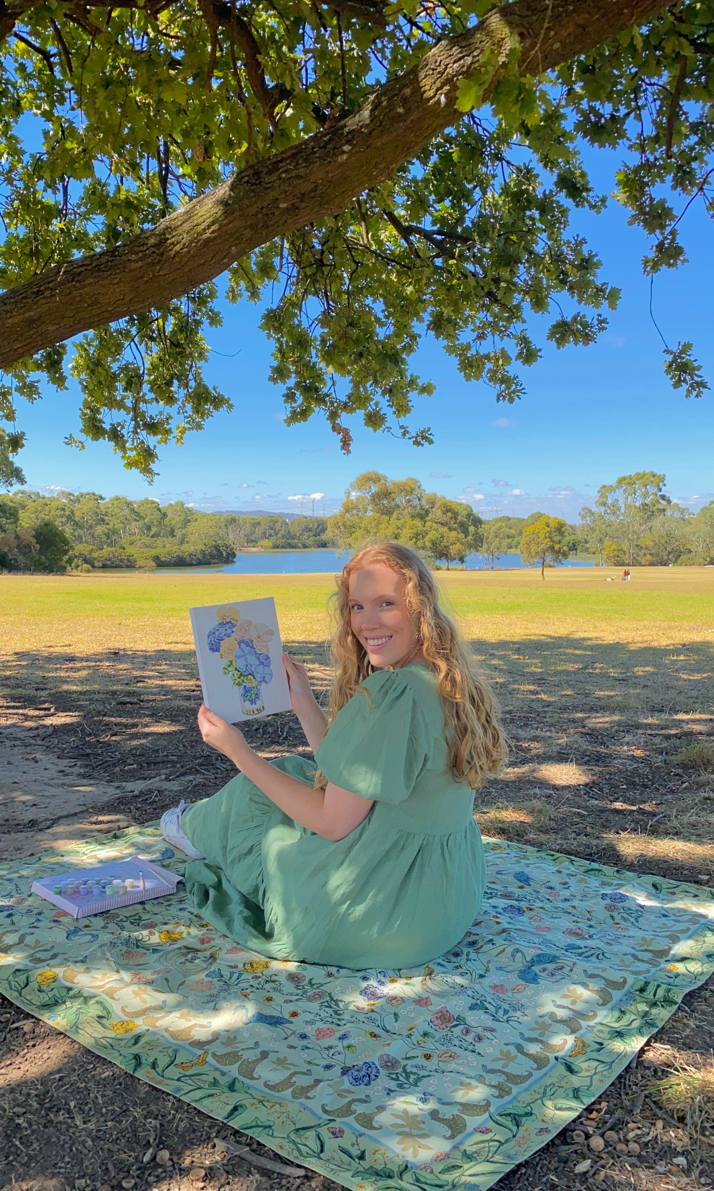A girl holding a finished Blueberry Jam mini frame canvas