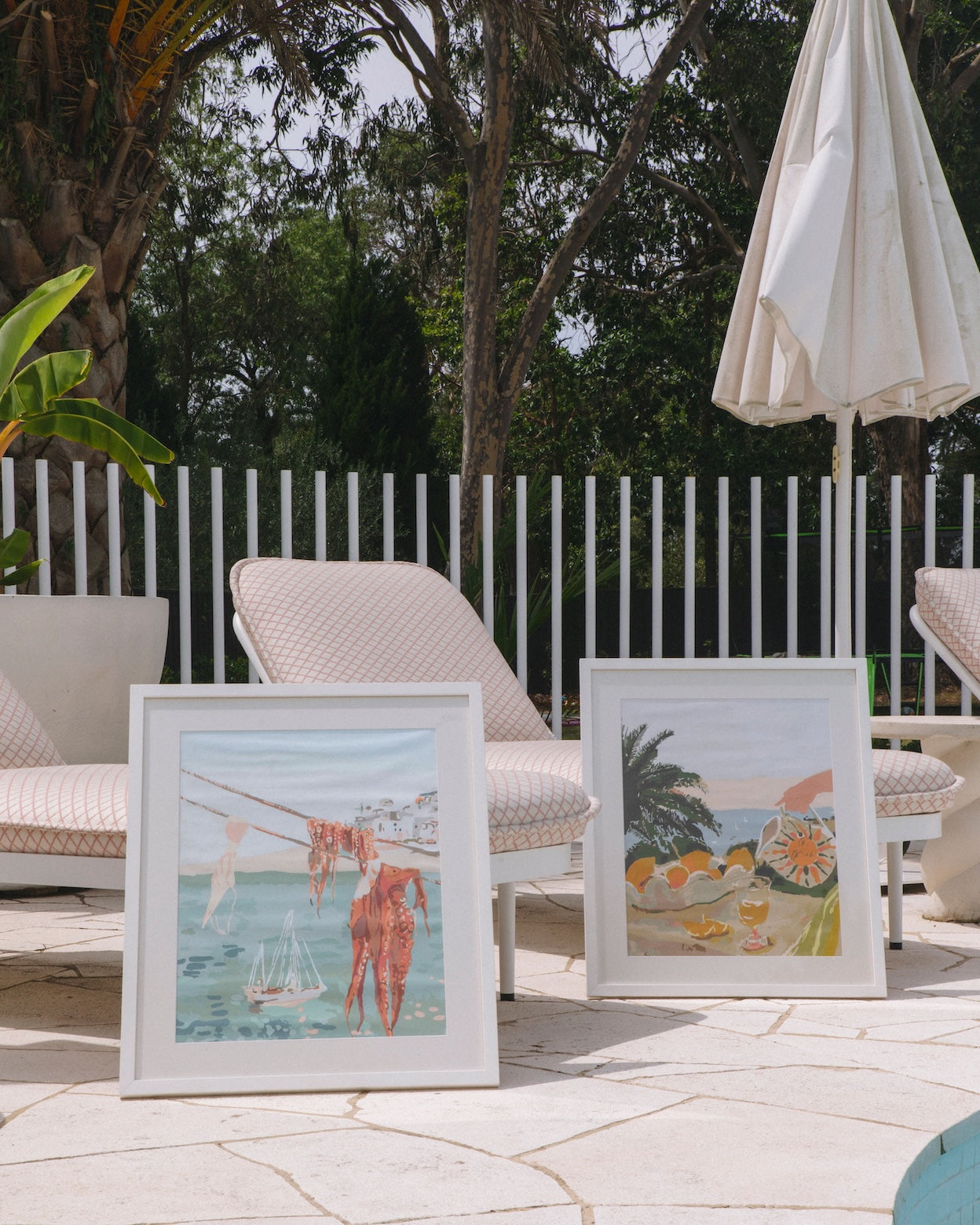 Paint Like Frida Laundry and Sun & Lemons Big Rolled Kits in white frames by the poolside