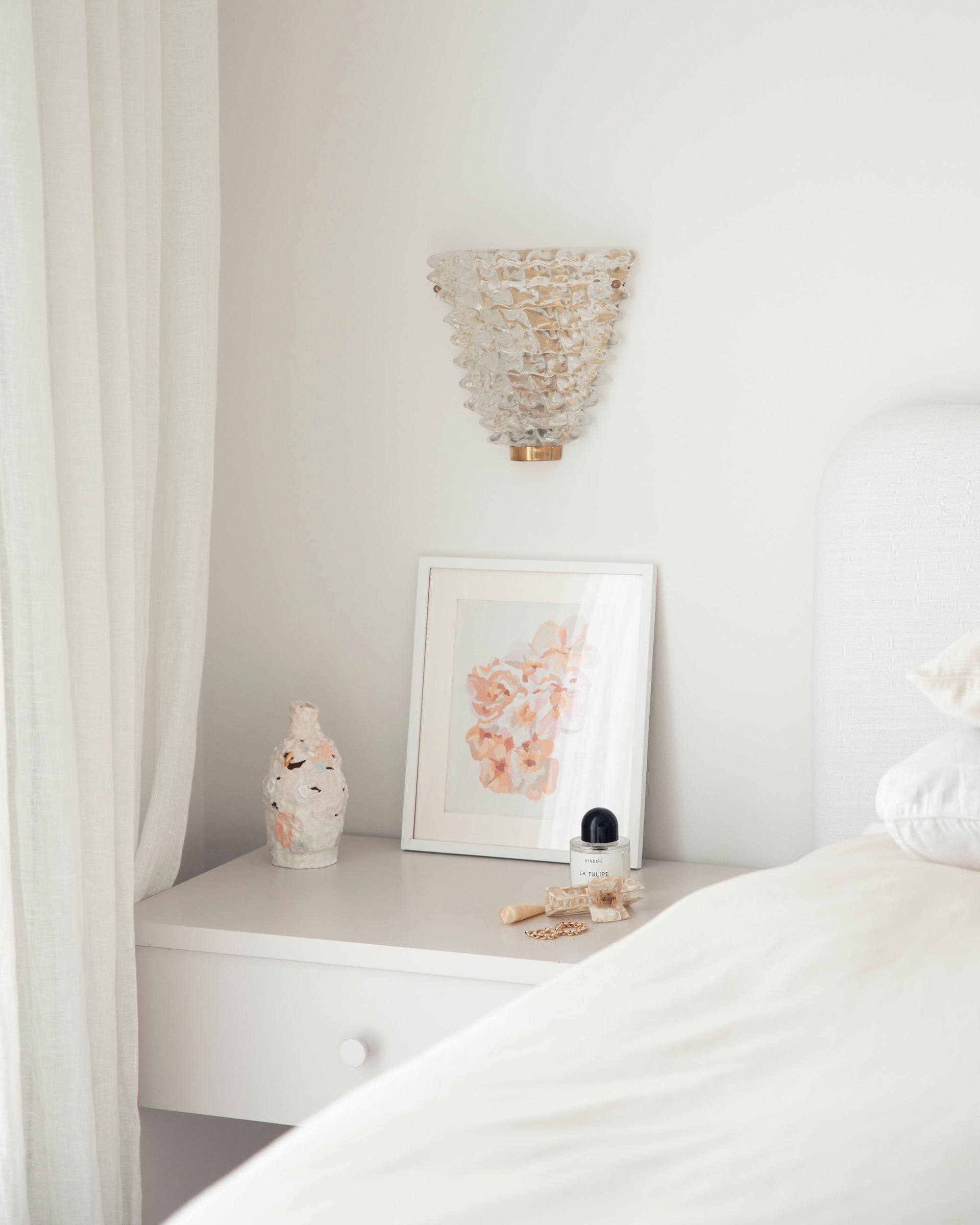 Paint Like Frida Little Bunch Mini Rolled Canvas in White Frame on top of a bedside table