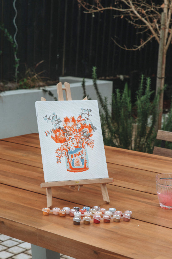 Completed Paint Like Frida Aussie Breakfast mini framed canvas painting in an easel.