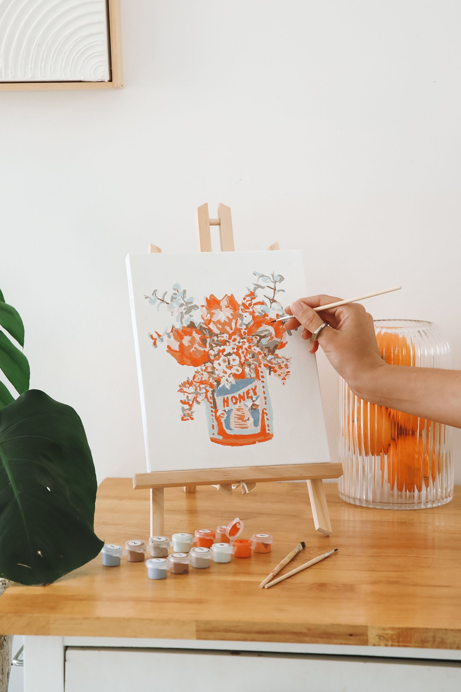 Paint Like Frida Aussie Breakfast mini framed kit in an easel while painting.