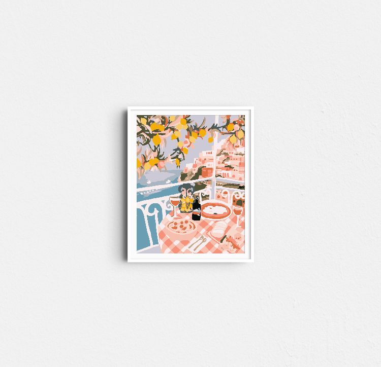 Completed Paint Like Frida Positano mini rolled canvas painting in white frame hanging on the wall.